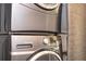 Grey stacked GE washer and dryer appliances in a laundry closet, offering convenience and space-saving design at 11081 Savannah Landing Cir, Orlando, FL 32832