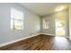 Bright and airy living room featuring durable wood-look flooring and natural light from the windows at 11081 Savannah Landing Cir, Orlando, FL 32832