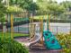 Community playground with slides, climbing bars, and a black metal fence at 11081 Savannah Landing Cir, Orlando, FL 32832