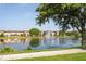 Scenic view of a pond with a fountain and townhomes at 11081 Savannah Landing Cir, Orlando, FL 32832