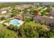 Resort-style community pool with ample seating, lush landscaping, and a shaded cabana at 11081 Savannah Landing Cir, Orlando, FL 32832