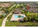 Community pool and cabana area surrounded by lush landscaping and neighboring townhomes at 11081 Savannah Landing Cir, Orlando, FL 32832