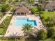 Sparkling community pool featuring plenty of lounge chairs and lush landscaping around the fenced area at 11081 Savannah Landing Cir, Orlando, FL 32832