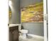Stylish half bathroom featuring a modern vanity, round mirror, and decorative wall art at 11081 Savannah Landing Cir, Orlando, FL 32832