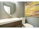 Chic powder room featuring a modern vanity, round mirror, and elegant finishes at 11081 Savannah Landing Cir, Orlando, FL 32832