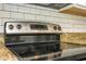Close-up of the electric cooktop set into the granite countertop with white subway tile backsplash at 11081 Savannah Landing Cir, Orlando, FL 32832