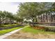 Street view of a neighborhood with landscaped sidewalks and community sign at 11081 Savannah Landing Cir, Orlando, FL 32832
