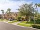 Charming townhome with manicured lawn, mature trees, and brick paver driveway at 11081 Savannah Landing Cir, Orlando, FL 32832
