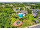 Aerial view of neighborhood amenities including a pool, playground, parking, and mature trees at 1122 Sandstone Run, Sanford, FL 32771