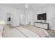 Spacious bedroom with closet, carpet flooring, a tv, and a stylish white cabinet at 1122 Sandstone Run, Sanford, FL 32771