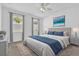 Comfortable bedroom with neutral tones, a plush bed, and natural light from two bright windows at 1122 Sandstone Run, Sanford, FL 32771