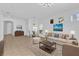 Bright living room with tile flooring, comfortable seating, and art pieces creating a welcoming space at 1122 Sandstone Run, Sanford, FL 32771