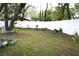 Backyard with a lawn, white fence, and trees at 1211 Phillip St, Winter Springs, FL 32708