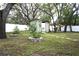 Backyard with a storage shed, trees, and a lawn at 1211 Phillip St, Winter Springs, FL 32708
