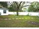Lawn featuring stepping stones, a white fence, and a large tree in the backyard at 1211 Phillip St, Winter Springs, FL 32708