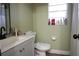 Bathroom with a modern vanity, mirror, a toilet, and a window with toiletries at 1211 Phillip St, Winter Springs, FL 32708