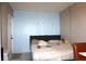 Bedroom with a large bed, light-blue wall, and doorway at 1211 Phillip St, Winter Springs, FL 32708