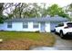 Charming single-story home with a gray roof, a white exterior, a well-manicured lawn, and a parked car at 1211 Phillip St, Winter Springs, FL 32708