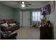 Inviting living room featuring a comfortable leather sofa, a ceiling fan, neutral walls, and natural light at 1211 Phillip St, Winter Springs, FL 32708