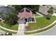 A lovely, two-story home features solar panels, a well-manicured lawn, and a charming, brick-lined walkway at 12643 Lakebrook Dr, Orlando, FL 32828