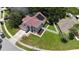 Charming gray home features solar panels, pristine landscaping, brick accents, and a white fenced backyard at 12643 Lakebrook Dr, Orlando, FL 32828