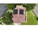 A neatly maintained house features solar panels, lush landscaping, and a well-kept yard in a tranquil neighborhood at 12643 Lakebrook Dr, Orlando, FL 32828