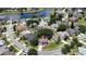 Overhead view of a gray home with solar panels in a neighborhood with lush greenery and a serene lake at 12643 Lakebrook Dr, Orlando, FL 32828