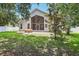 Home's well-maintained backyard and patio area surrounded by mature trees at 12643 Lakebrook Dr, Orlando, FL 32828
