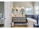 This is a bathroom with dual sinks, modern lighting, and a separate tub with a black fixture set at 12643 Lakebrook Dr, Orlando, FL 32828
