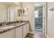 Well-lit bathroom featuring double sinks, granite countertops, and a walk-in shower at 12643 Lakebrook Dr, Orlando, FL 32828