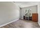 Bedroom featuring a large window, hardwood flooring, and a fireplace at 12643 Lakebrook Dr, Orlando, FL 32828