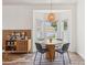 Dining area featuring a round table, modern light fixture, and a bay window at 12643 Lakebrook Dr, Orlando, FL 32828