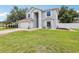 Charming two-story home featuring an attached garage and manicured lawn at 12643 Lakebrook Dr, Orlando, FL 32828