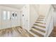 Bright foyer with wood-look floors, staircase, and double entry doors at 12643 Lakebrook Dr, Orlando, FL 32828