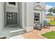 Close-up of front porch with double doors, two chairs, and brick walkway at 12643 Lakebrook Dr, Orlando, FL 32828