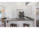 Kitchen bar area with granite counters, bar stools, and stainless steel appliances at 12643 Lakebrook Dr, Orlando, FL 32828
