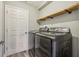 Laundry room with front-load washer and dryer, and wooden shelving at 12643 Lakebrook Dr, Orlando, FL 32828