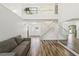 Spacious living room with wood-look floors, staircase, large windows, and a full wall mirror at 12643 Lakebrook Dr, Orlando, FL 32828
