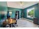 Stylish home office featuring a modern desk setup, accent wall, wood-look flooring, and a view at 12643 Lakebrook Dr, Orlando, FL 32828