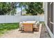 Backyard patio featuring an outdoor dining set with comfortable seating, surrounded by a privacy fence at 12643 Lakebrook Dr, Orlando, FL 32828