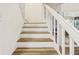 Bright staircase featuring white risers and wood treads at 12643 Lakebrook Dr, Orlando, FL 32828