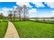 An expansive backyard with a well-maintained lawn and a walkway leading towards the serene lake at 1275 Lake Shadow Cir # 13106, Maitland, FL 32751