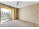 Bright bedroom with a ceiling fan, carpet flooring, and a sliding door to the patio at 1275 Lake Shadow Cir # 13106, Maitland, FL 32751