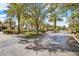 Gated community entrance with lush landscaping, mature trees, and condominium buildings at 1275 Lake Shadow Cir # 13106, Maitland, FL 32751