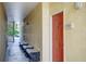 Apartment 13106 with a red front door and benches for sitting outside near the stairwell at 1275 Lake Shadow Cir # 13106, Maitland, FL 32751