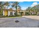 Attractive condominium clubhouse with white columns, manicured landscaping, and circular driveway at 1275 Lake Shadow Cir # 13106, Maitland, FL 32751
