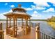 Charming community gazebo by the lake with seating, providing a relaxing spot with beautiful water views at 1275 Lake Shadow Cir # 13106, Maitland, FL 32751