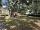 Community playground with mature trees, slides, and picnic tables for outdoor fun at 1275 Lake Shadow Cir # 13106, Maitland, FL 32751