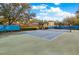 Community tennis court surrounded by mature trees, offering a recreational space at 1275 Lake Shadow Cir # 13106, Maitland, FL 32751