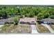 Overhead shot of a single-Gathering home featuring a manicured lawn and mature trees at 1299 Buccaneer Ave, Deltona, FL 32725